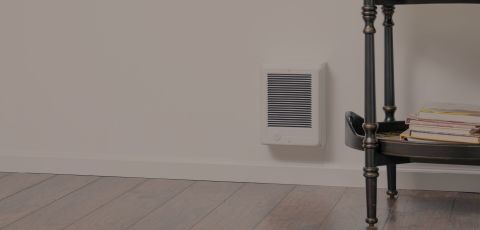 A living space with a Cadet heater mounted onto the wall