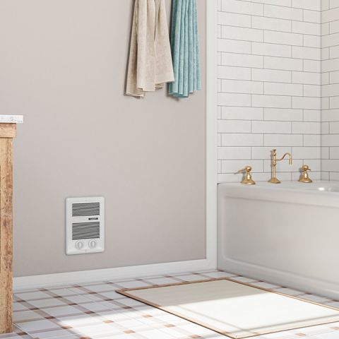 A bathroom with a Com-Pak wall heater mounted near the bottom of the wall
